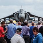 front of a harrier with a crowd of people photograping it